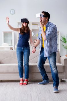 Young family playing games with virtual reality glasses