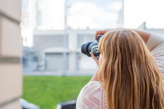 Body positive. Portrait of overweight woman taking pictures with a camera outdoors