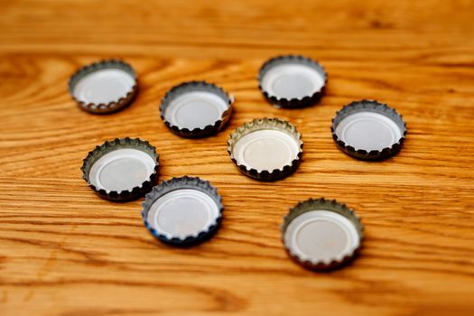 Beer bottle caps on a wooden table