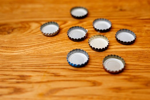 Beer bottle caps on a wooden table