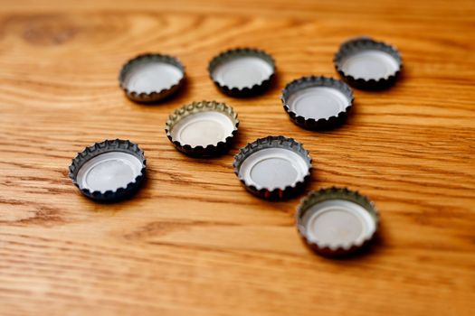 Beer bottle caps on a wooden table