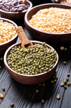 Various dried legumes top view flat lay on white wooden background