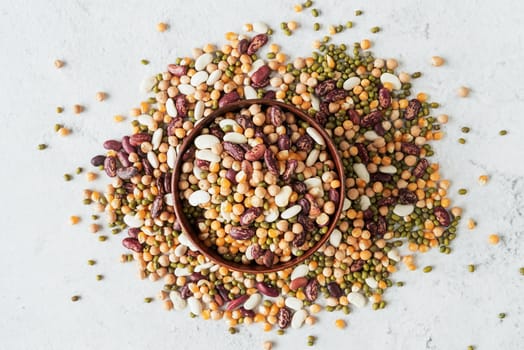 a wooden bowl with assorted mixed legumes scatter top view flat lay