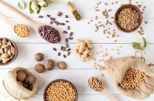 Various dried legumes top view flat lay on white wooden background