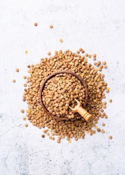 Lentils top view on gray background, minimal style. Wooden bowl with lentils top view flat lay