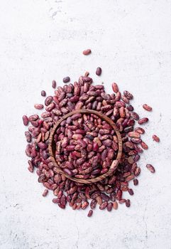 Kidney beans top view on gray background, minimal style. Wooden bowl with green mung beans top view flat lay