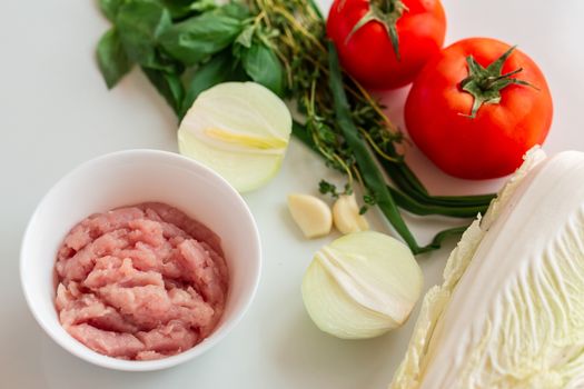 Cooking cabbage rolls with chicken mince at home. Chicken fillet sliced into small pieces for the mince on the plate