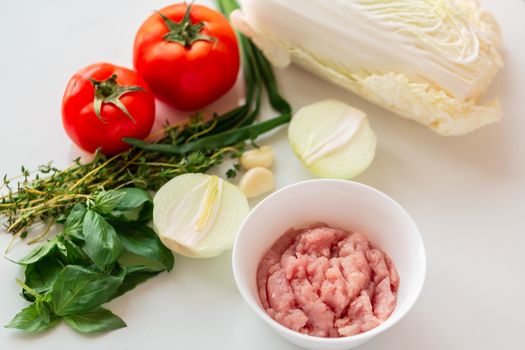 Cooking chicken tenders at home. Chicken fillet sliced into small pieces for the mince on the plate