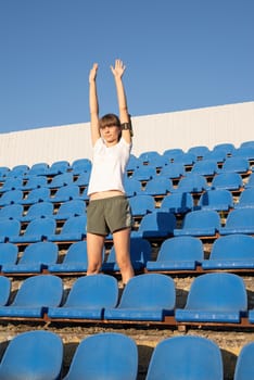 Healthy lifestyle concept. Teenage doing sports alone at the empty stadium