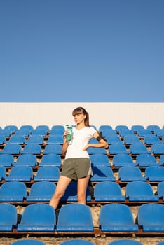 Healthy lifestyle concept. Teenage doing sports alone at the empty stadium