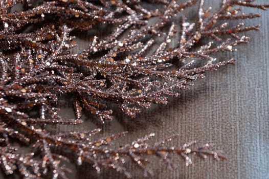 brown gilded branch on a brown background for Christmas blank.