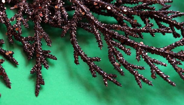 brown gilded branch on a green background for Christmas blank.