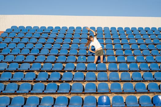 Healthy lifestyle concept. Teenage doing sports alone at the empty stadium