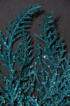 turquoise sparkling branch on a black background for Christmas blank.