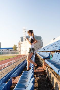 Active lifestyle. Teenager girl working out at the staduim running down the stairs
