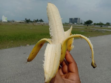 tasty and healthy expanded banana closeup on hand