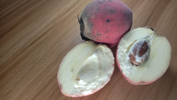 Tasty And Healthy Velvet apple Closeup on Wooden Table