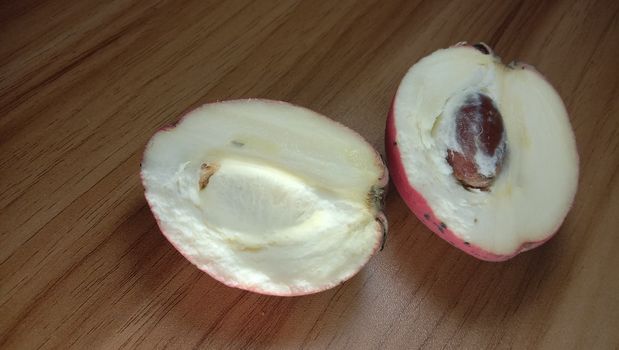 Tasty And Healthy Velvet apple Closeup on Wooden Table