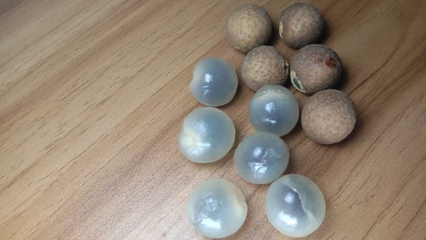 Tasty and Healthy Longan Stock on Wooden Table