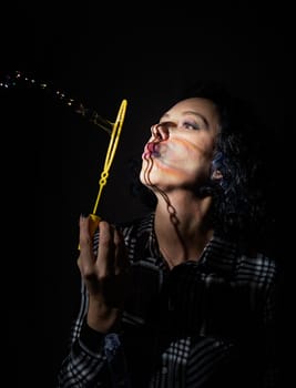 Light and shadow portrait. Beautiful young woman with a shadow pattern of soap bubbles on her face