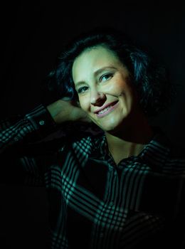 Light and shadow portrait. Portrait of a beautiful young woman with colored light on the face and body