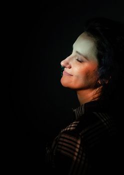 Light and shadow portrait. Portrait of a beautiful young woman with colored light on the face and body