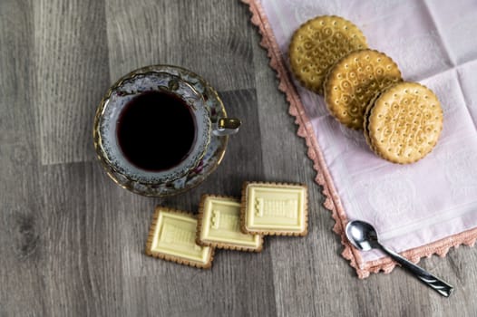 combination of food with tea and biscuits on a wooden table from above