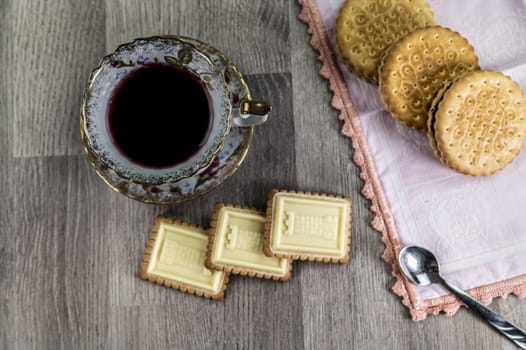 combination of food with tea and biscuits on a wooden table from above
