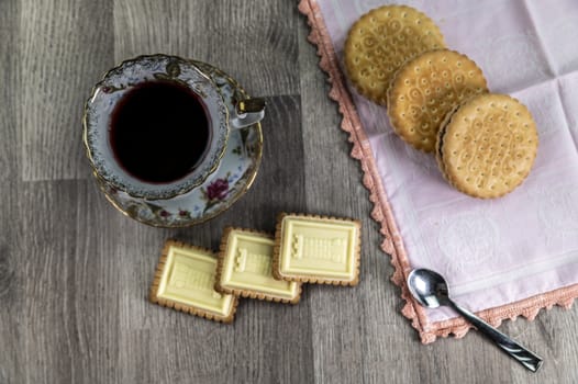combination of food with tea and biscuits on a wooden table from above
