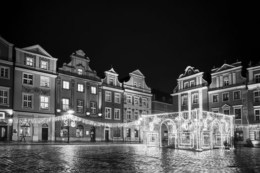 The Market Square with historic tenement houses andl and christmas decorations in city of Poznan, monochrome