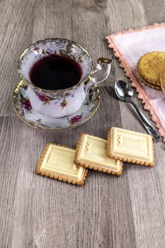 combination of food with tea and biscuits on a wooden table from above