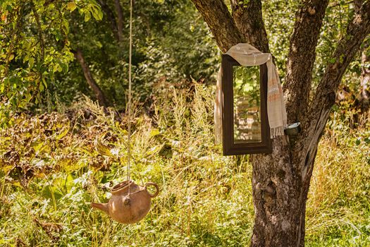 Washstand and mirror on a tree in the countryside