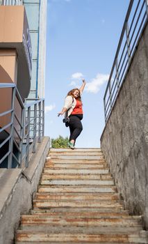 Travel, tourism and entertainment. Plus size woman photographer working at the street