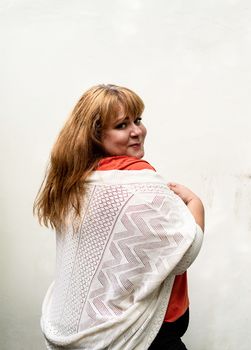 Portrait of a young beautiful caucasian woman smiling, view from behind