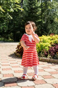 cute asian infant girl dancing in the park