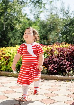 cute asian infant girl dancing in the park