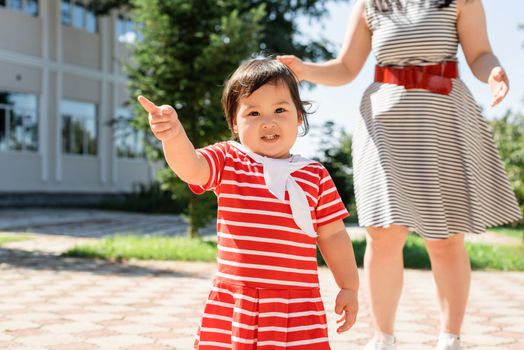 Multiethnic family. Happy multiracial family of mother and daughter walking in the park