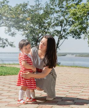 Multiethnic family. Happy multiracial family of mother and daughter walking in the park