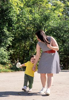 Multiethnic family. Happy multiracial family of mother and daughter walking in the park