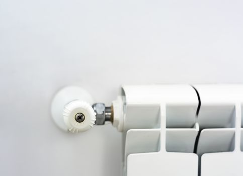 close-up view of the white knob that adjusts the temperature of the radiator. Heating and winter season