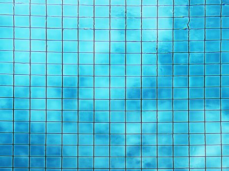 Top view of swimming pool bottom caustics ripple and flow with waves background. Summer background. Texture of water surface. 