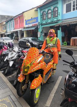 Phuket Thailand 30 May 2018 : Colorful Robot Security in Phuket Walking Sreet at daylight in Phuket Old Town. View of the street food market at dusk with a crowd of locals and tourists.