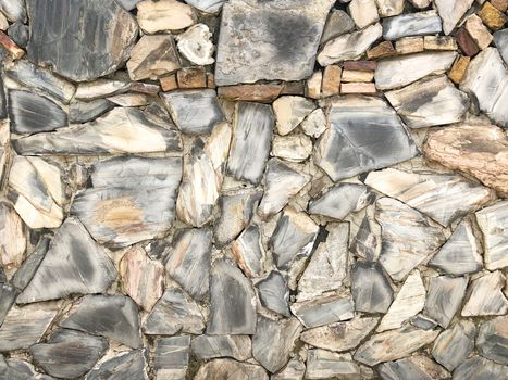 Rock wall pattern gray color of modern style design decorative uneven cracked real stone wall surface with cement