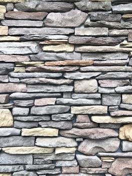Rock wall pattern gray color of modern style design decorative uneven cracked real stone wall surface with cement