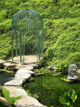 Big cage in a beautiful green garden 