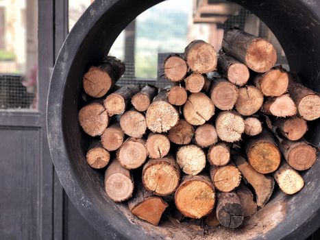 A pile of stacked firewood, prepared for cooking pizza in the Restaurant