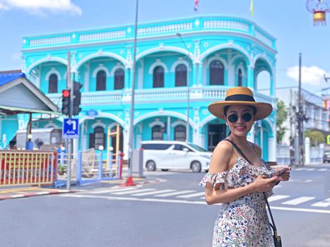 Young woman on beautiful walking street. Travelling in Phuket Old Town in Thailand. 