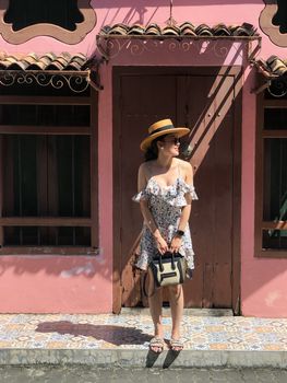 Young woman on beautiful walking street. Travelling in Phuket Old Town in Thailand. 