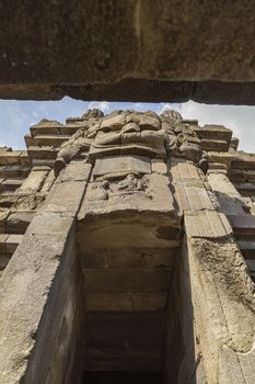 Huge carved stone face, in one of the shrines of the Prambanan ancient Hindu temple complex, Rara Jonggrang, in the Special, Yogyakarta region, Indonesia.