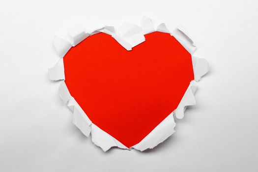 Torn white paper heart over red background with copy space for text, Valentine's day love concept